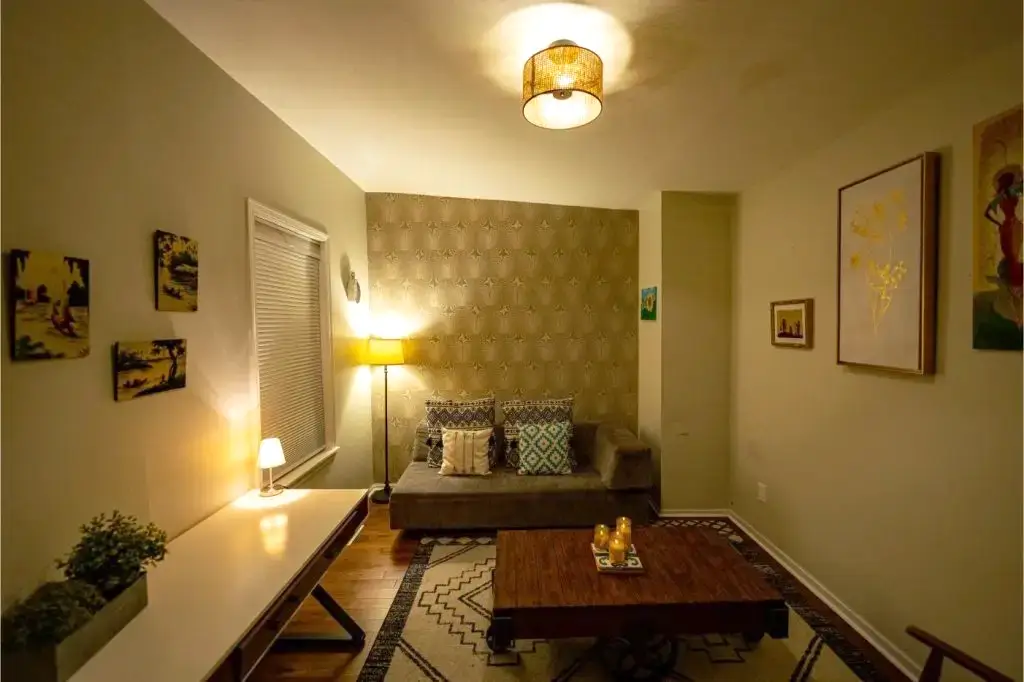 Similar to the fourth, with warm lighting, artwork, and decorative accents.